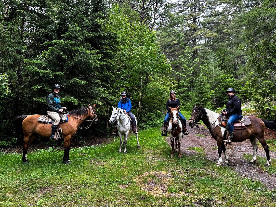 A group of travel writers ride horses at Von Doelers Ranch in North Bay
