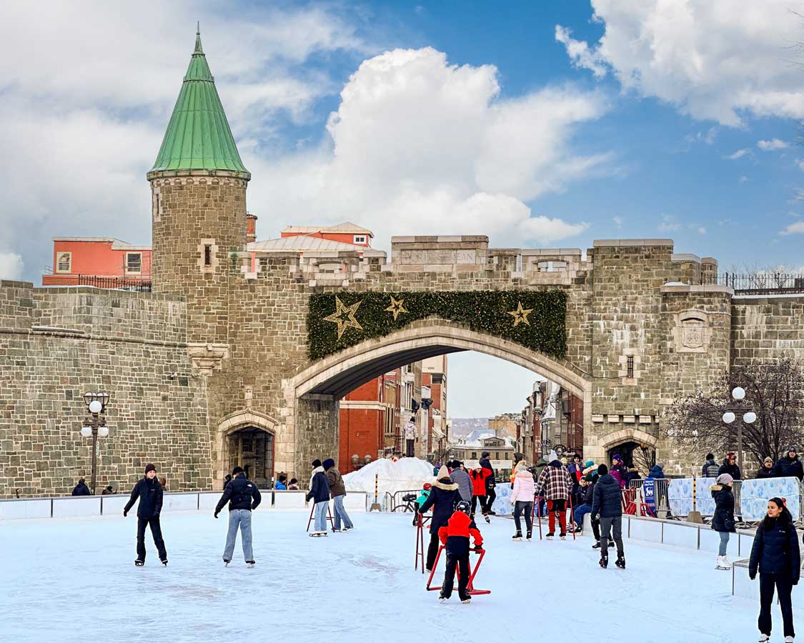 Skaters enjoy the sunshine at a Christmas Market rink at Place D'Youville in Quebec City