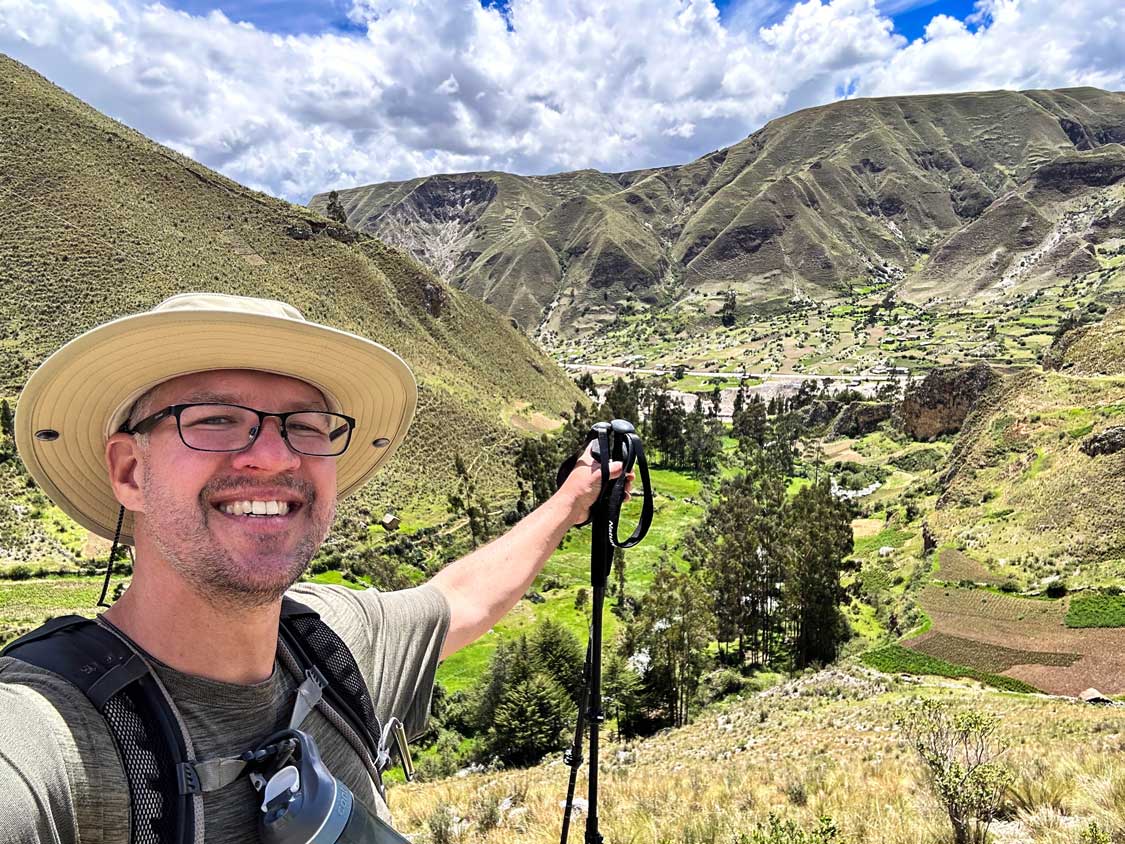 A hiker points to the end of the trail along the Royal Inca Road