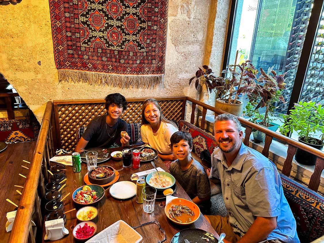 A family eats Testi Kebabs at Dibek Restaurant