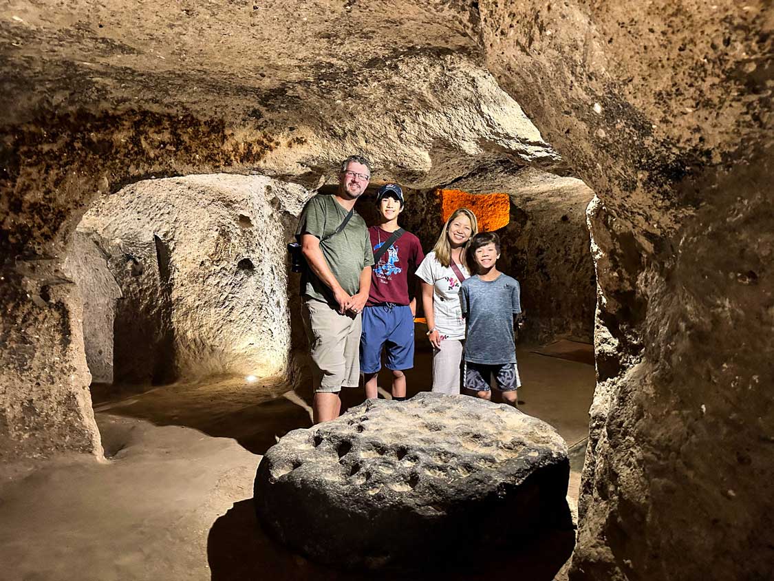 A family walks through the Derinkuyu underground city in Cappadocia