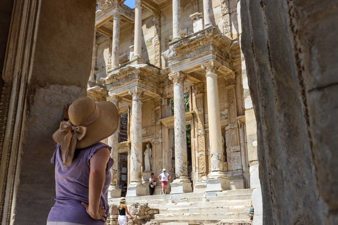 A woman gazes up at the ruins of the Library of Ephesus near Kusadasi, Turkiye