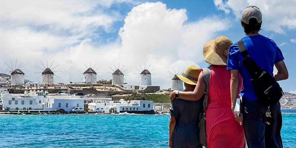A family looking at windmills on Mykonos on a Greek Islands cruise with Celestyal cruises