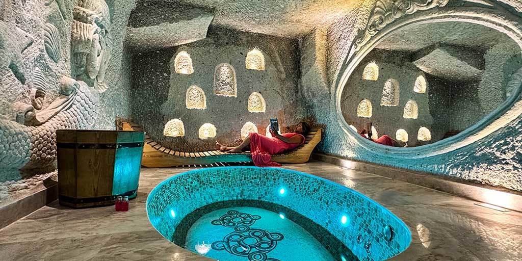 A woman relaxing by a private bath in one of the best Cappadocia cave hotels