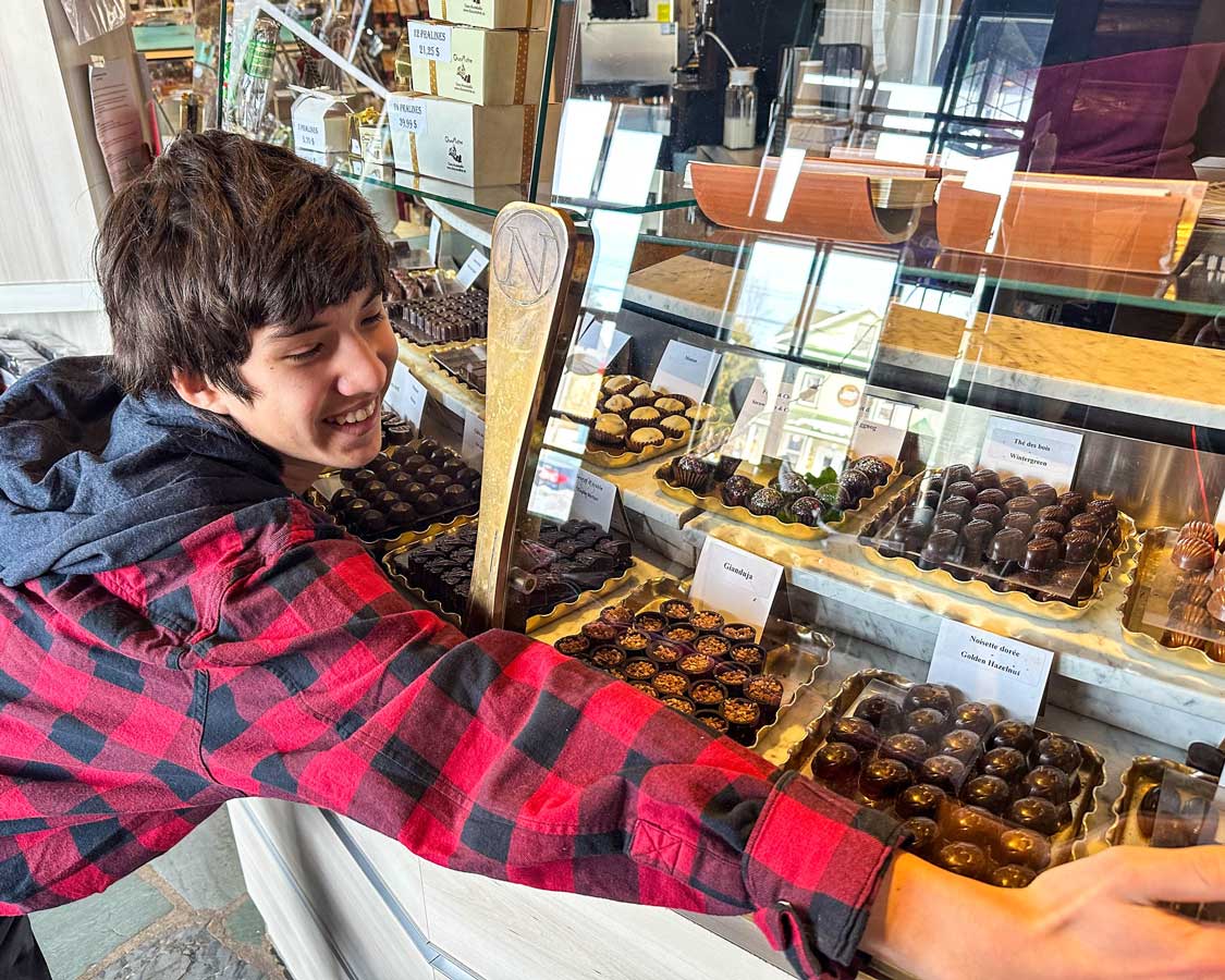 A boy hugs a chocolage display at Chocomotive in Montebello, Quebec