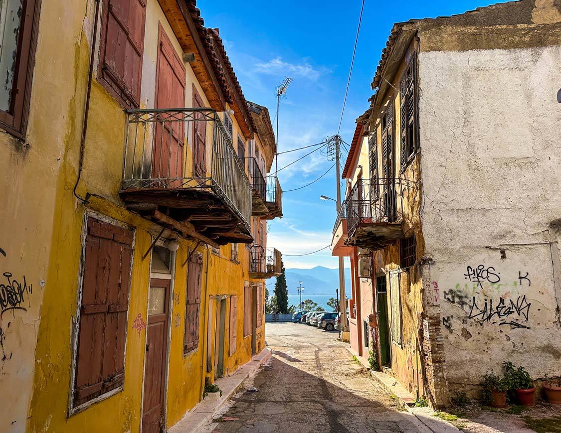 Colorfully painted run-down homes in Napflio, Greece