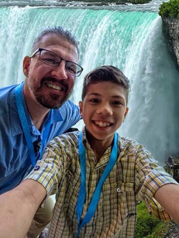 A father and son share a selfie on a one-day Niagara Falls itinerary for families