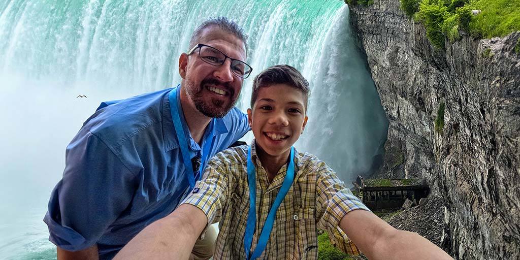 A father and son share a selfie on a one-day Niagara Falls itinerary for families