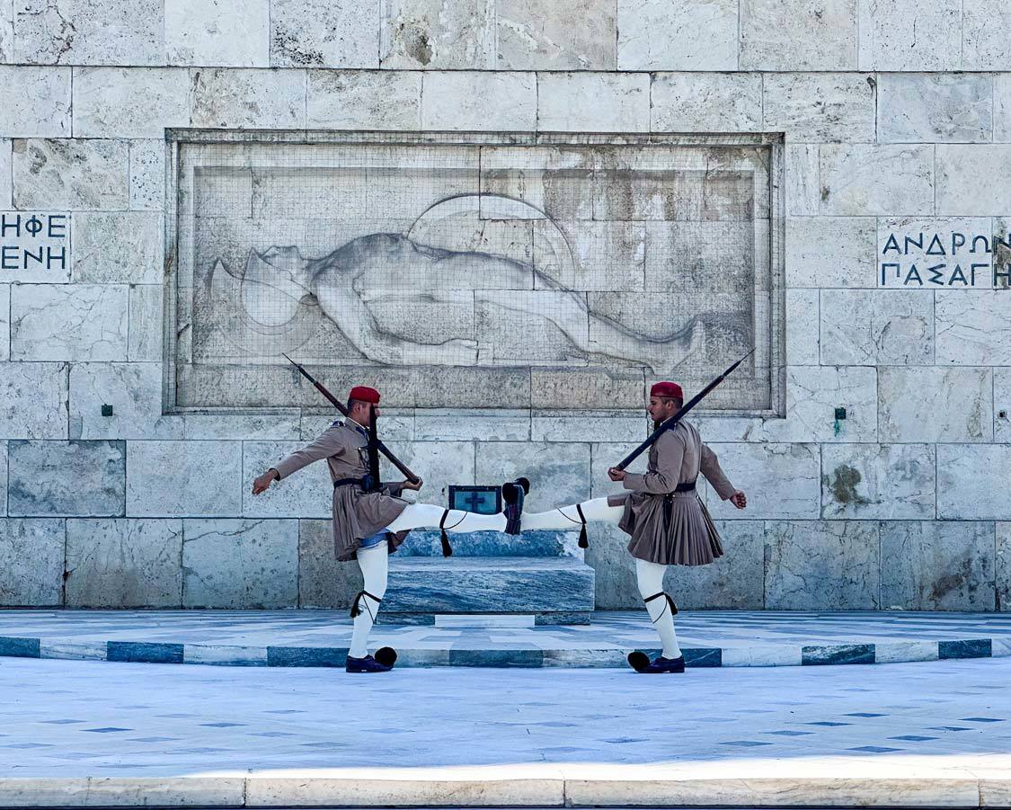 Two guards connect feet during a changing of the guards ceremony in Athens, Greece