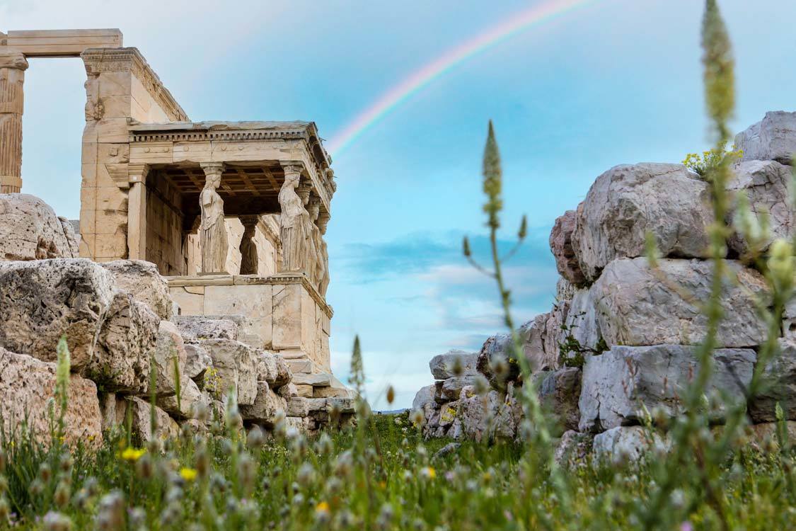 The Temple of Athena at the Athens Acropolis beneath a rainbow