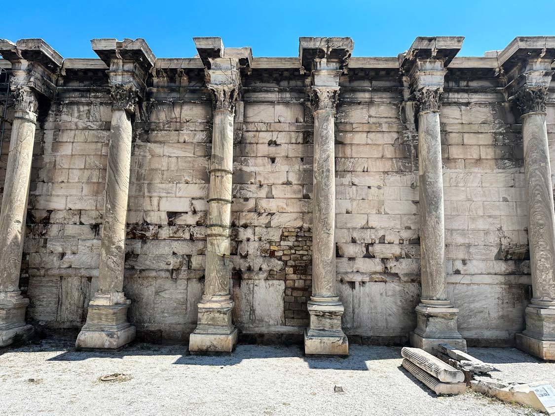 The walls of Hadrian's Library in Athens, Greece with tall columns connected by bricks