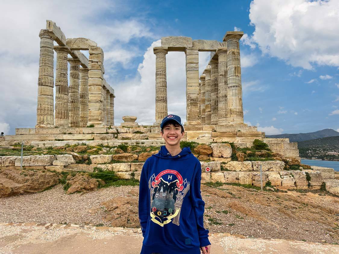 Cohen Wagar smiles in front of the Temple of Poseidon near Cape Sounion