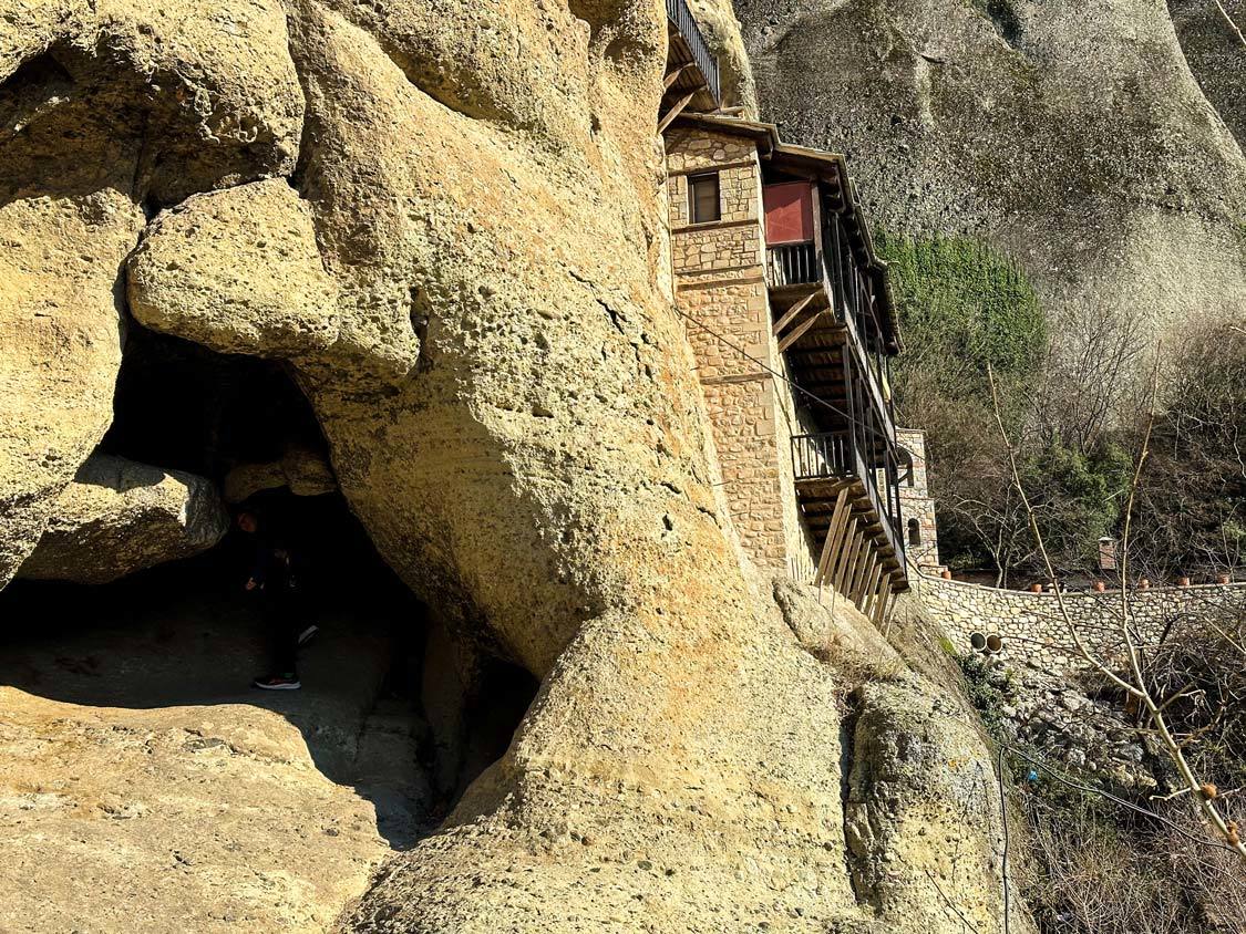 A boy walks into a cave next to the Monastery of Saint Anthony