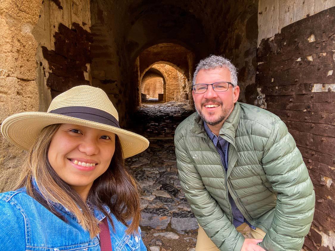 A couple explores the underground tunnels of the Monemvasia Acropolis