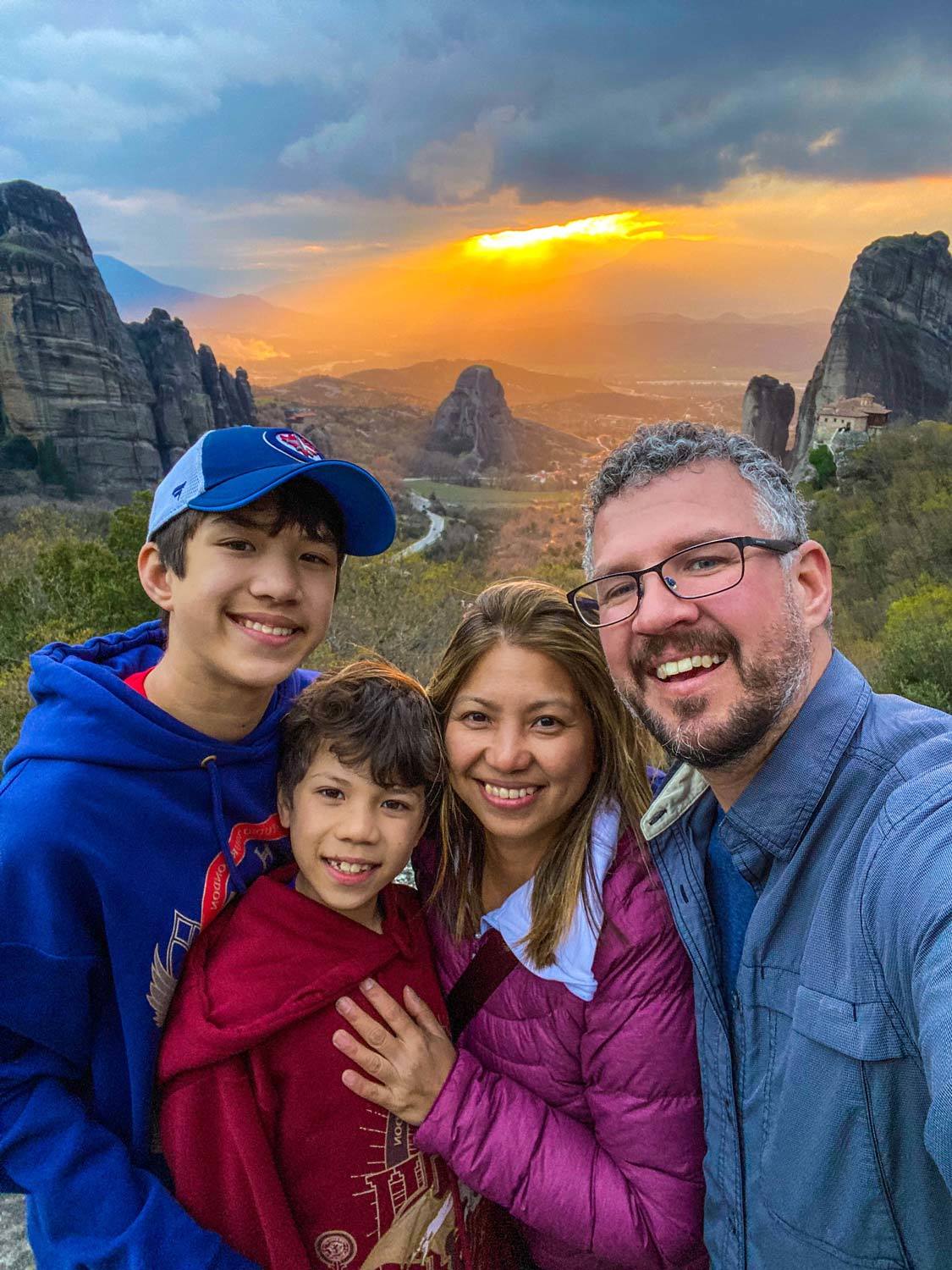 The Wandering Wagars at sunset in Meteora, Greece during their roadtrip through Greece