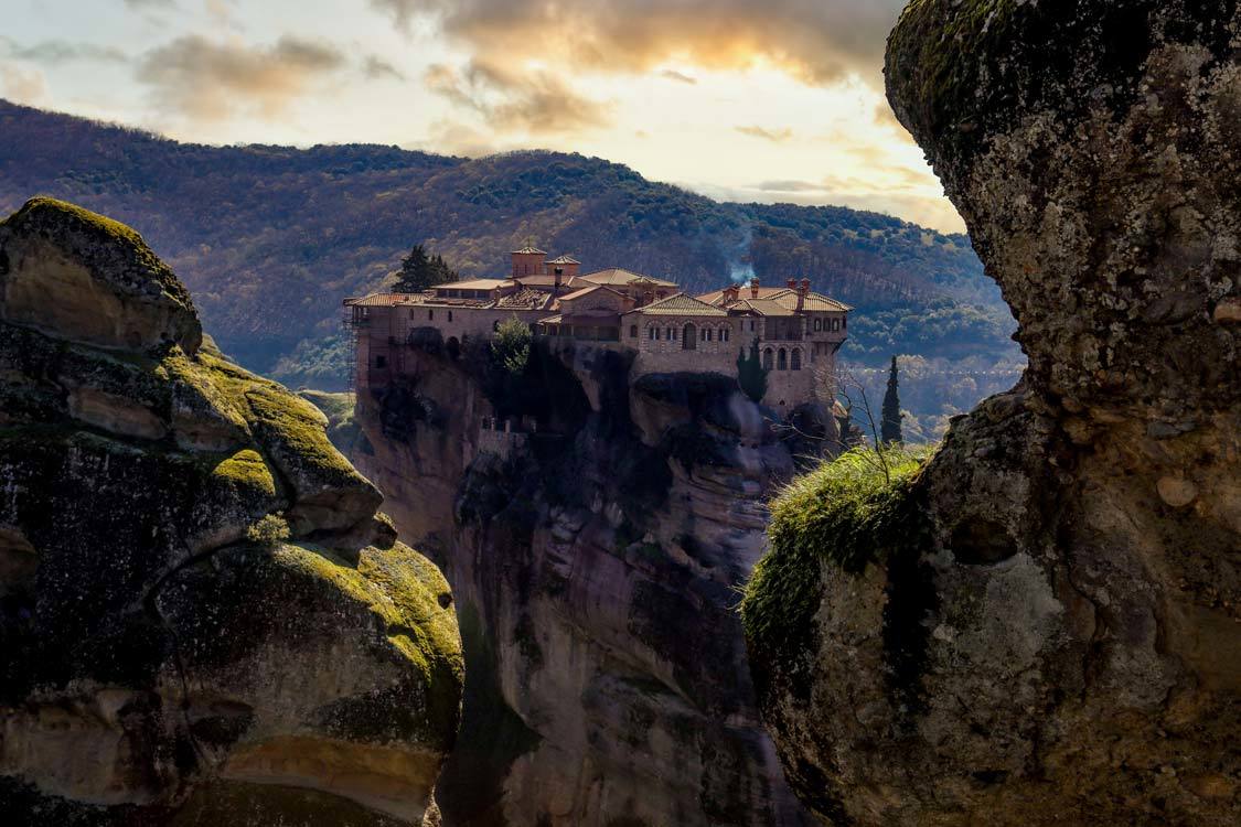 A hilltop monastery in Meteora, Greece at sunset