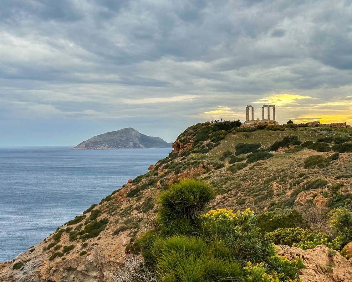 Crowds gather at Cape Sounion to watch the sunset from the Temple of Poseidon