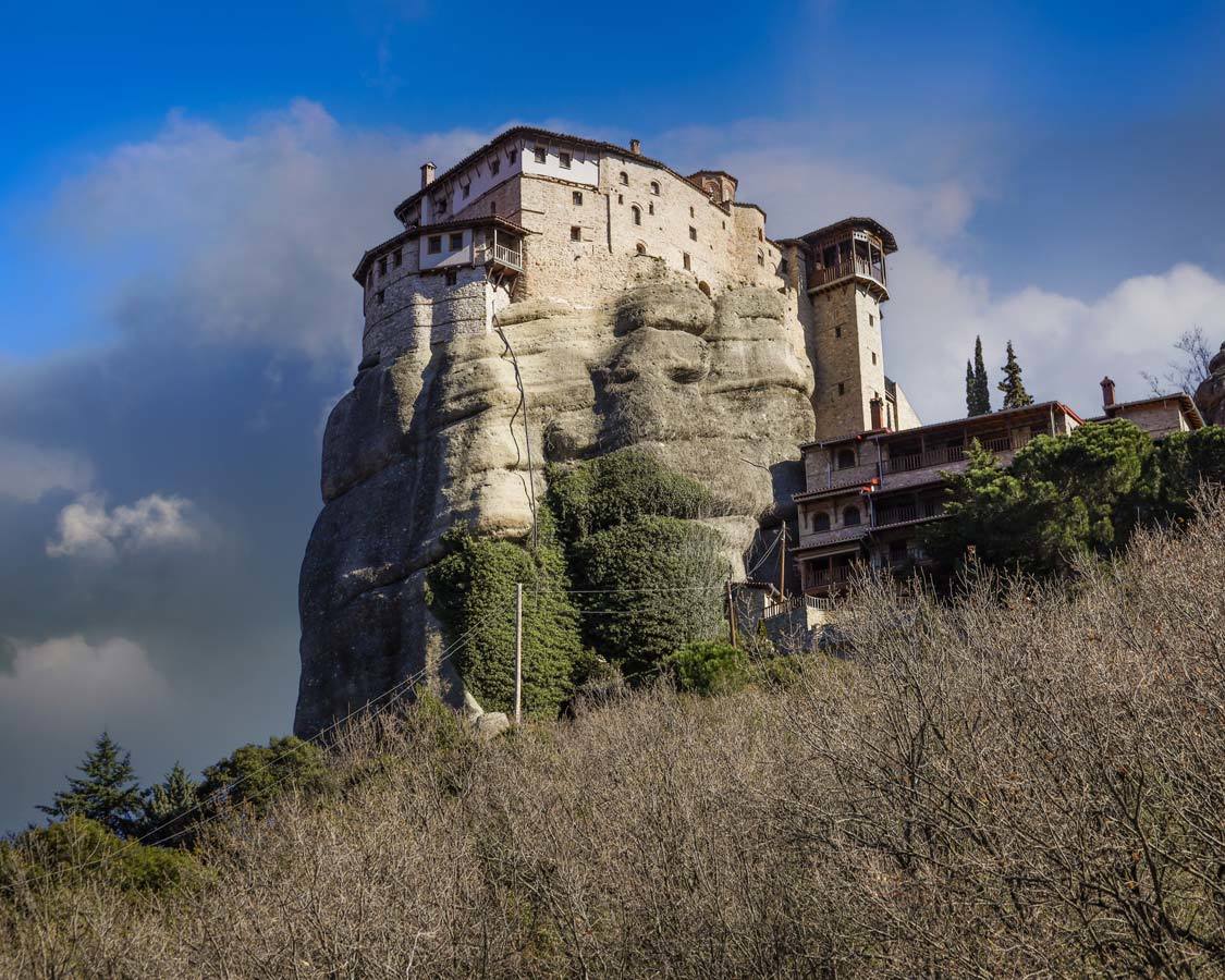 An ancient Monastery of Saint Nicholas perched on top of a rocky outcrop in Meteora, Greece