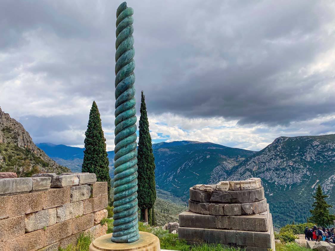 A green, bronze serpent column in Delphi Greece