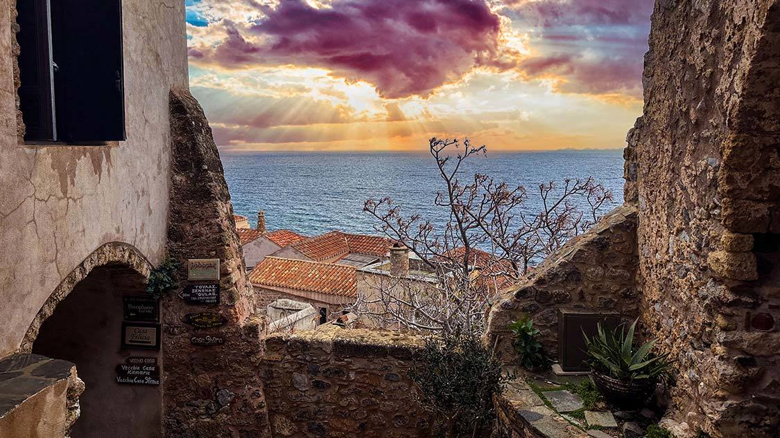 Sunset between historic buildings in Monemvasia, Greece