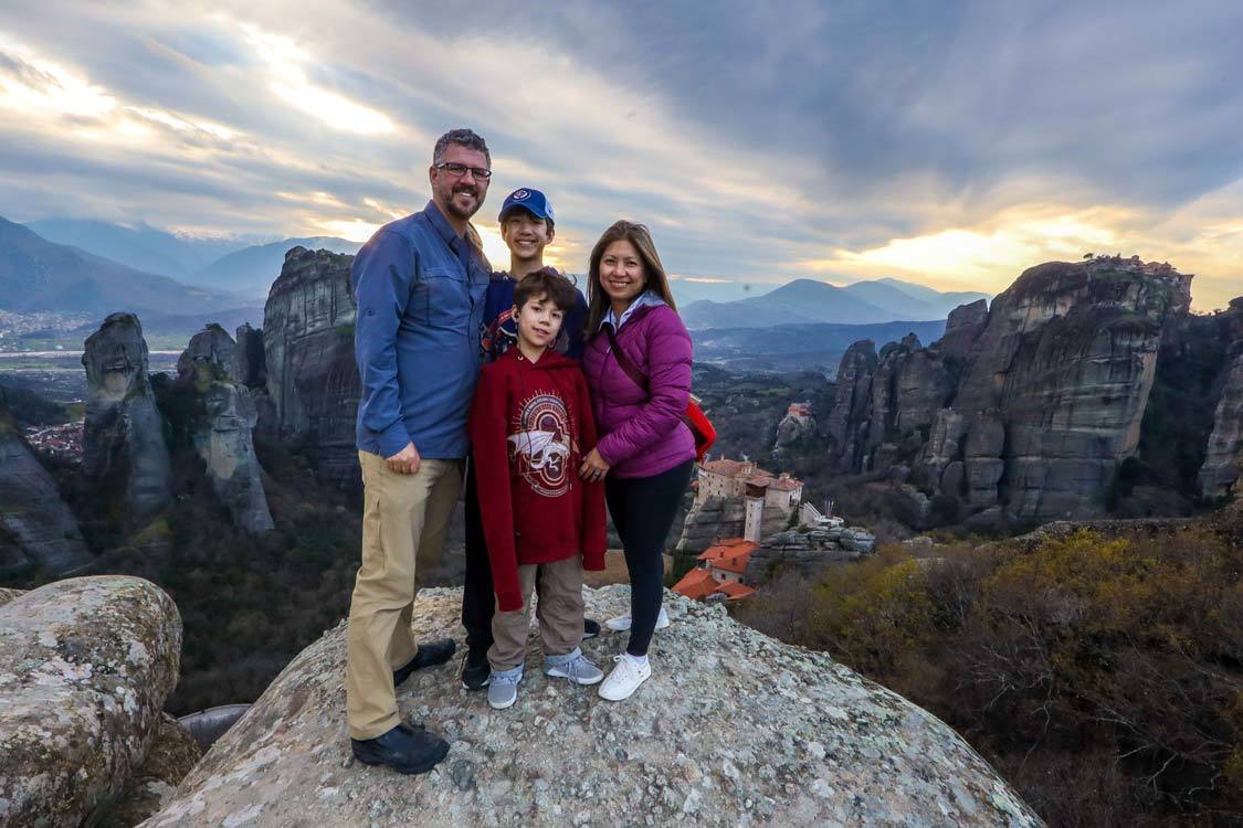 A family poses for a photo at the main observation deck in Meteora, Greece