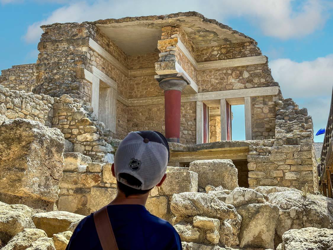 A boy looks at the ruins of the Palace of Knossos in Heraklion, Crete