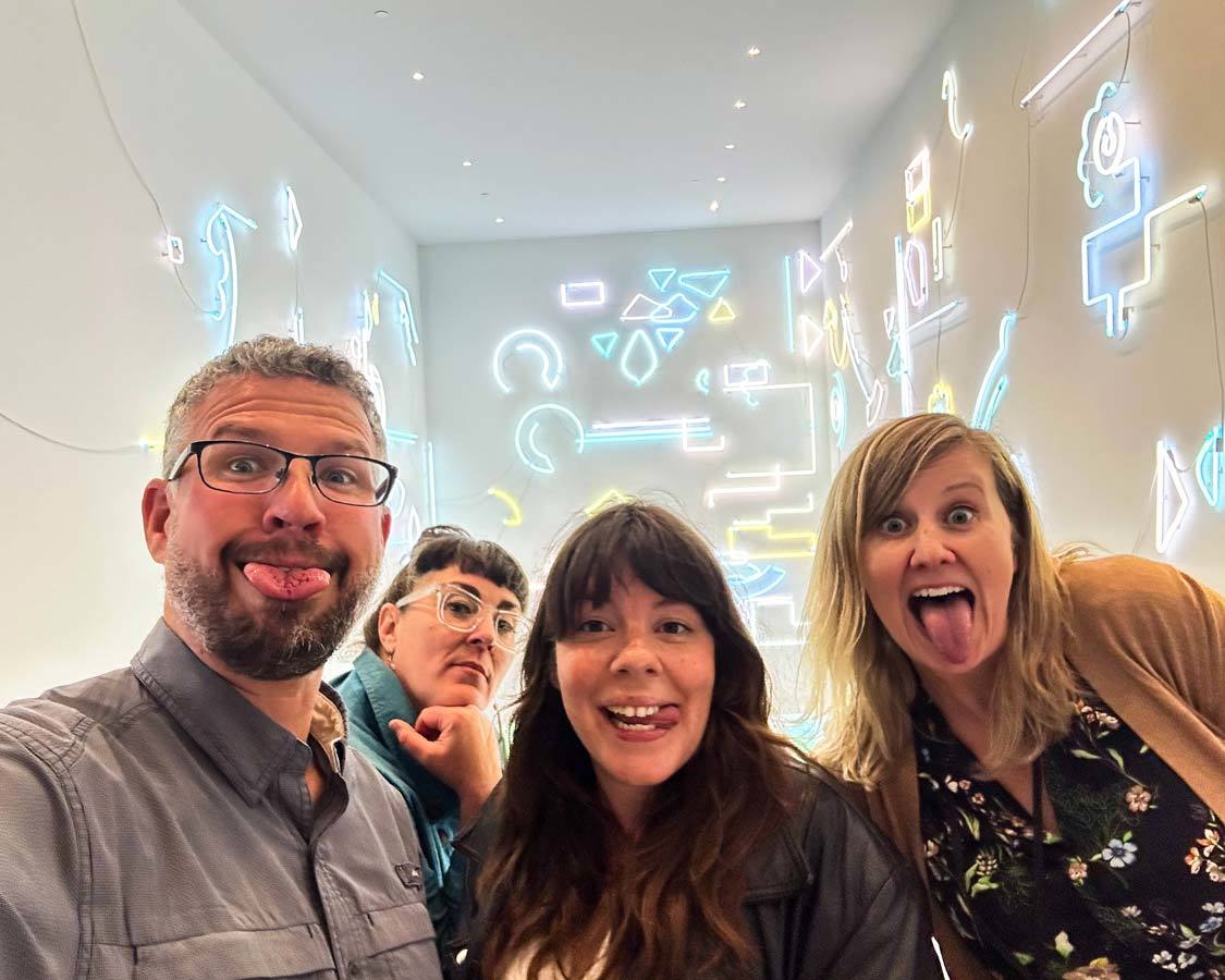 A man and three women make silly faces at the Remai Modern museum in Saskatoon, Saskatchewan