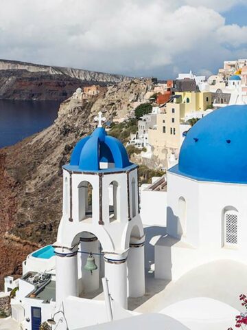 Blue roofed buildings in Oia, Santorini on one day in Santorini itinerary