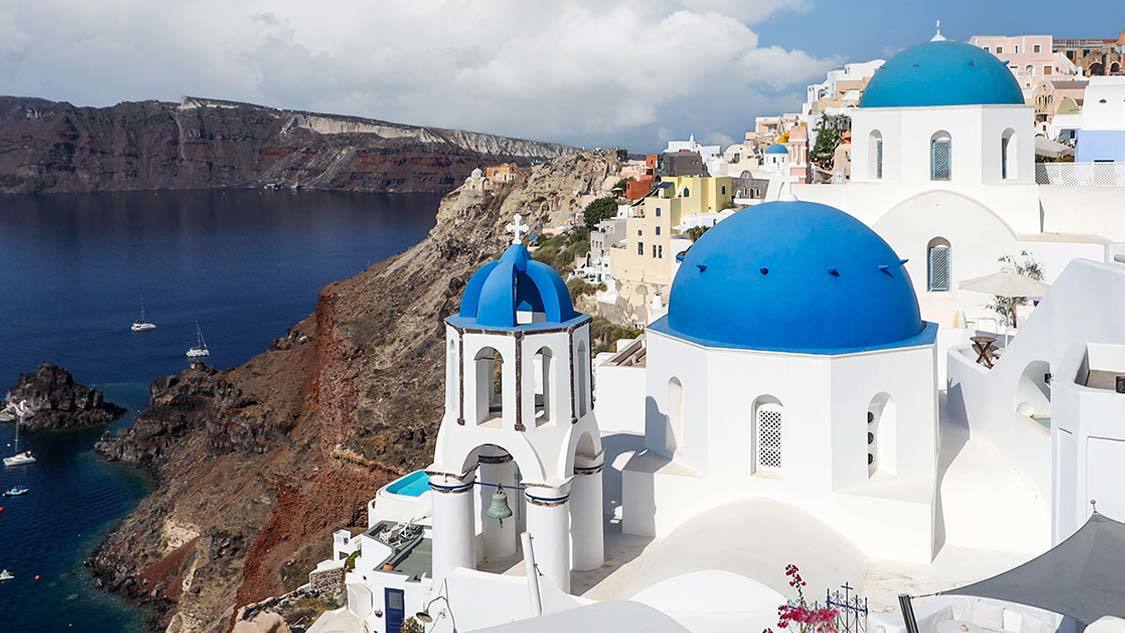 Blue roofed buildings in Oia, Santorini on one day in Santorini itinerary