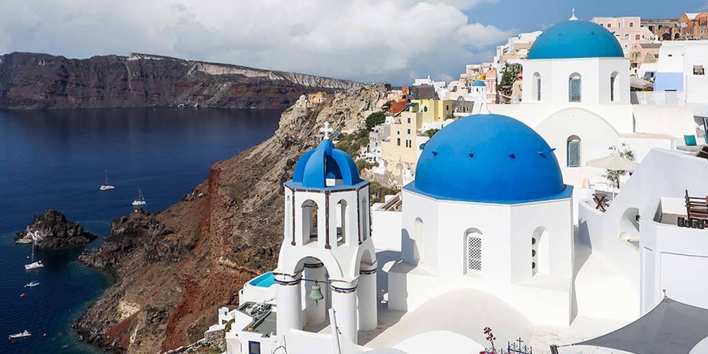 Blue roofed buildings in Oia, Santorini on one day in Santorini itinerary