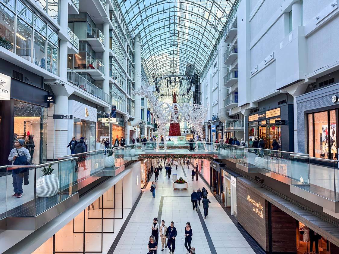 Shoppers walk through the Toronto Eaton Centre while its decorated in winter displays