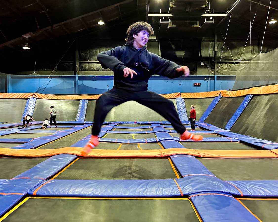 A teenager bounces on a trampoline at SkyZone Mississauga