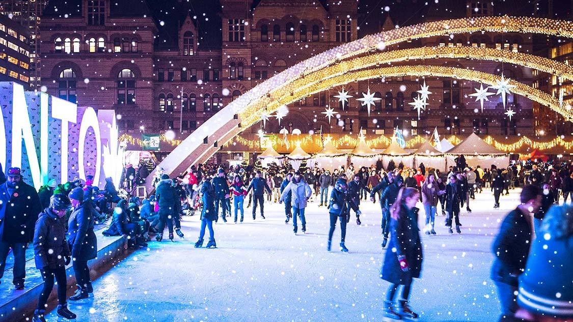 Skaters celebrating winter in Toronto at Nathan Phillips Square