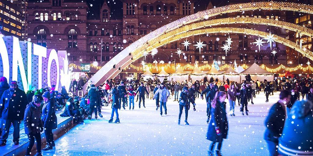 Skaters celebrating winter in Toronto at Nathan Phillips Square