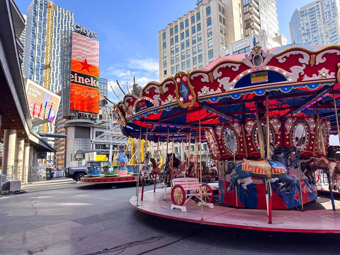 A merry-go-round waits for riders at Yonge-Dundas Square during winter in Toronto