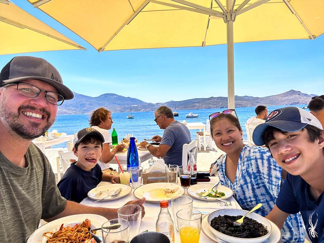 A family enjoys traditional Greek food at Astakas Cafe in Klima on Milos, Greece