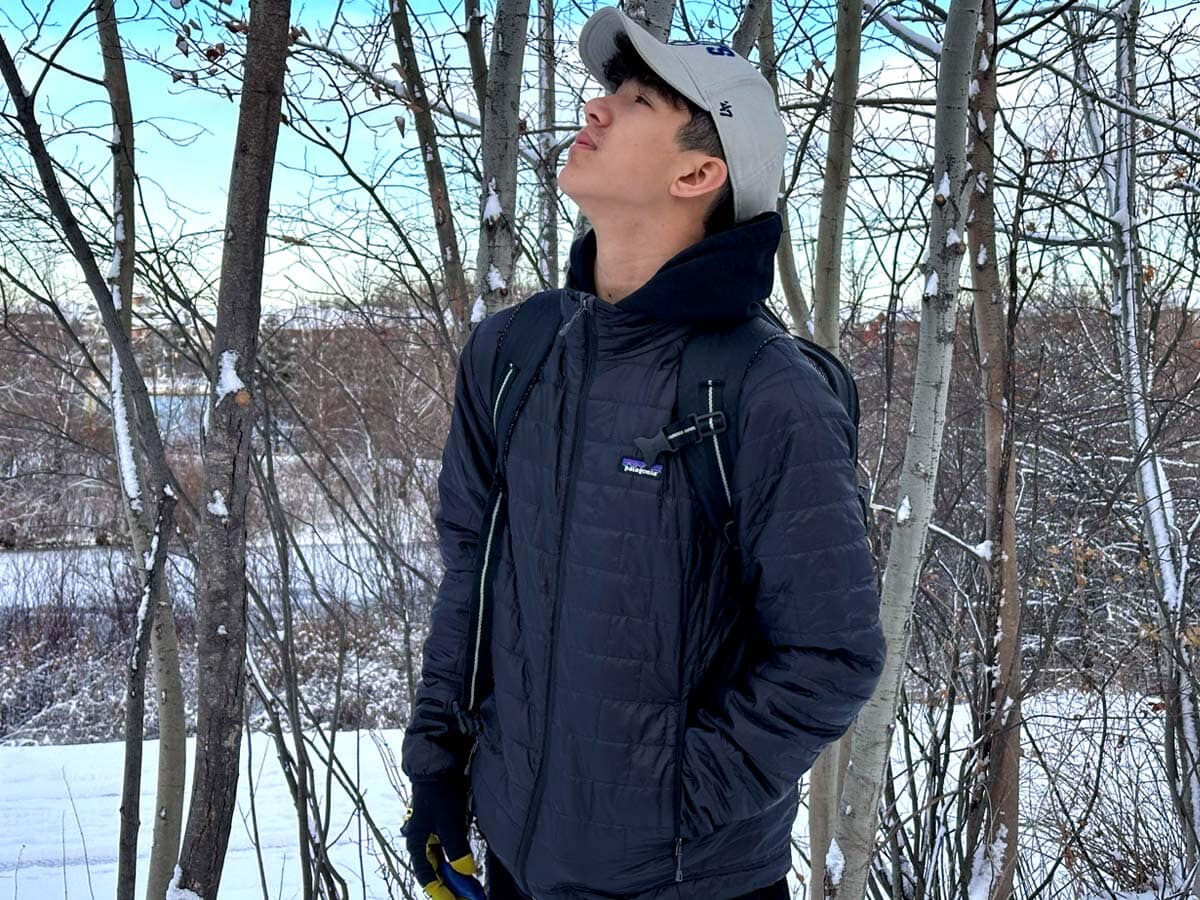 A teenager wears a Patagonia travel jacket while exploring Canada