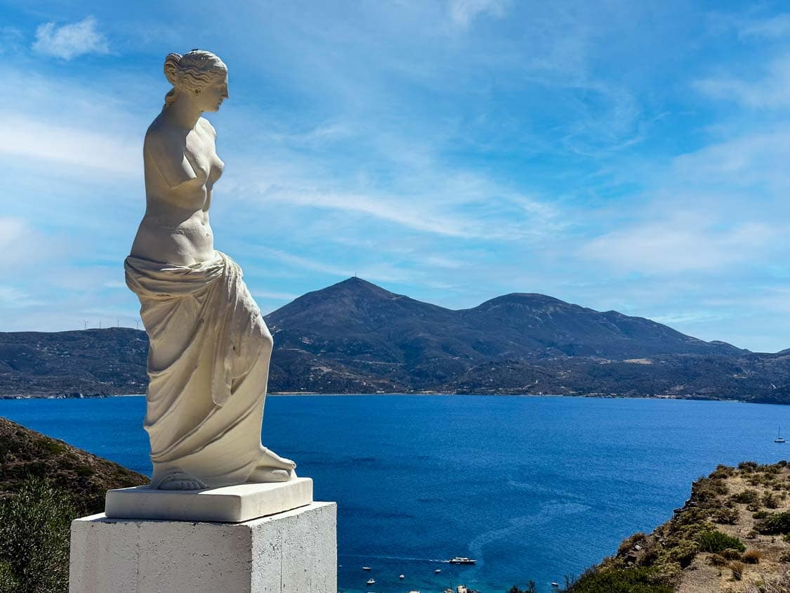 A replica of the Venus de Milo stands proudly looking out over the Aegean Sea in Milos, Greece