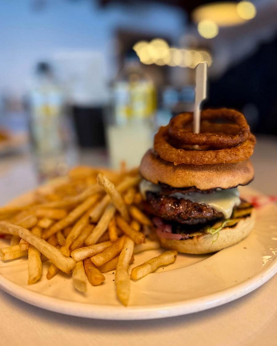 Deluxe hamburger topped with onion rings at Matha Bistro, Quebec