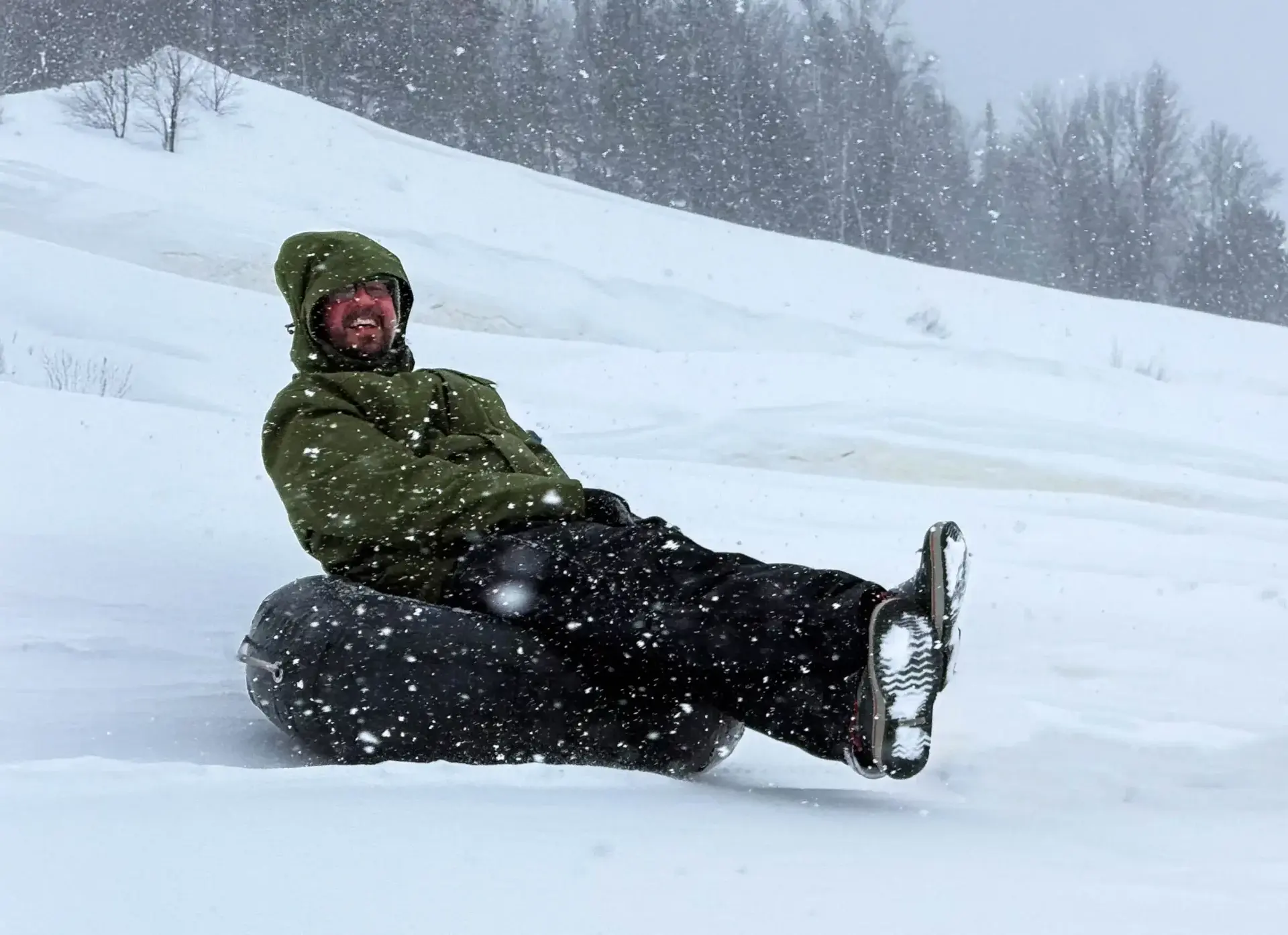 Kevin Wagar sliding down a hill on a tube at Matha Super Glissades, Quebec tubing hill