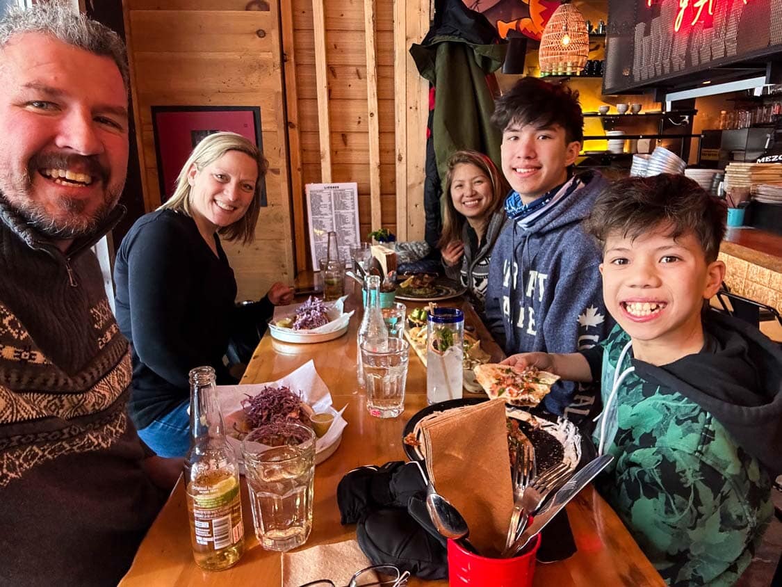 A group of friends take a selfie at Mezcal Taqueria on a Quebec winter road trip