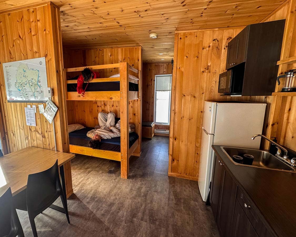 Two boys laugh while lying in a bunk bed at 2800 du Parc in Shawinigan, Quebec