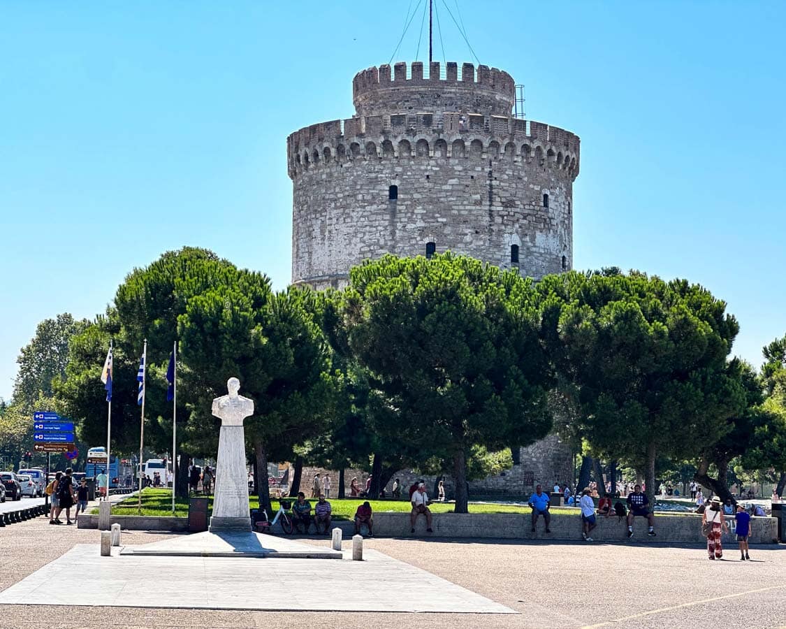 The white tower on the Thessaloniki waterfront rises above a grove of trees