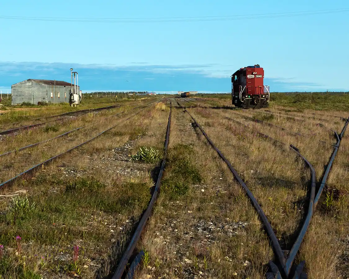 A lone train car sits among criss-crossed tracks at the Churchill Manitoba Train Station