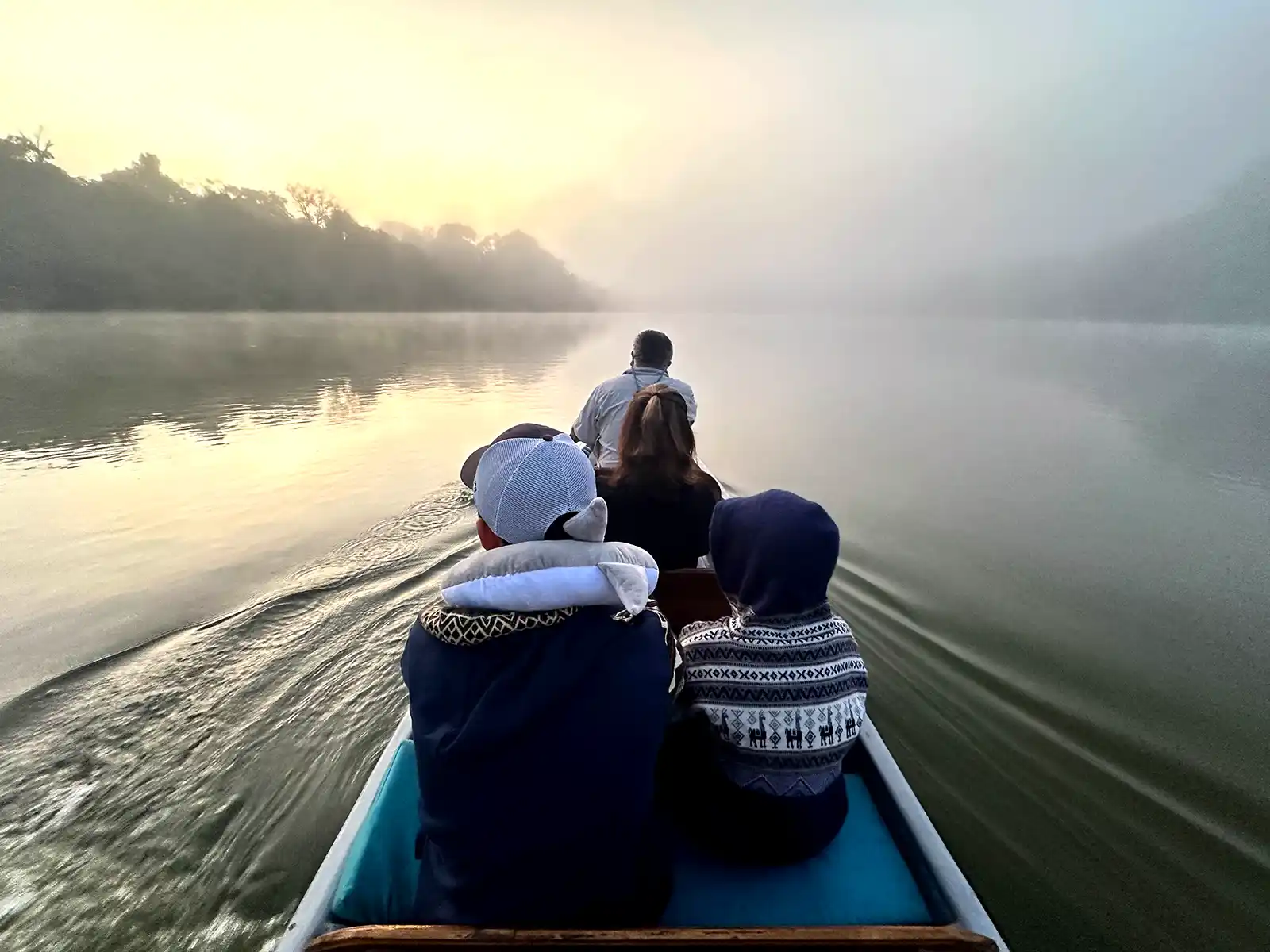 A family takes a sunrise canoe trip in the Amazon Rainforest