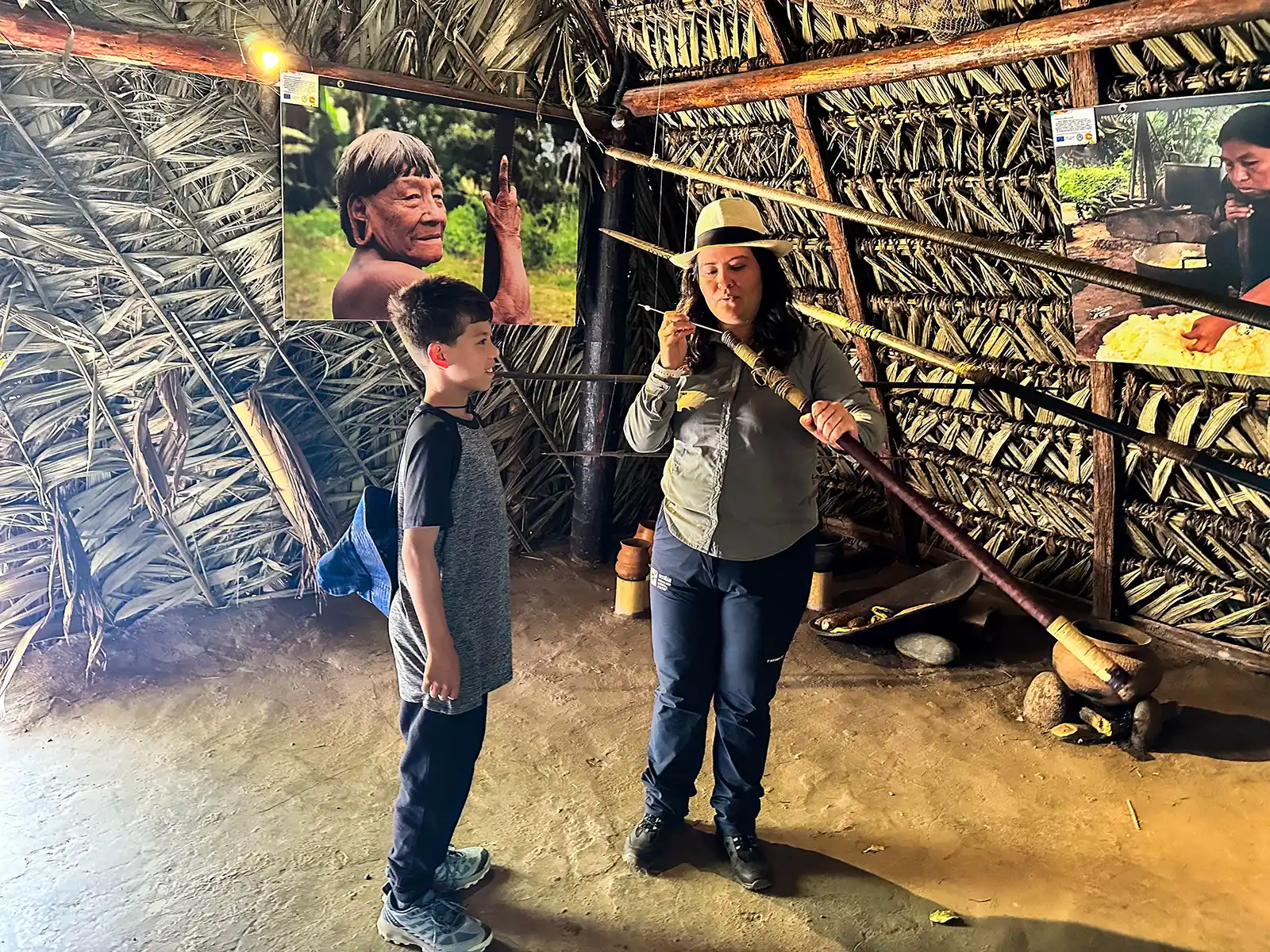 A young boy learns to use a dart gun at the Itinan Museum in Quito
