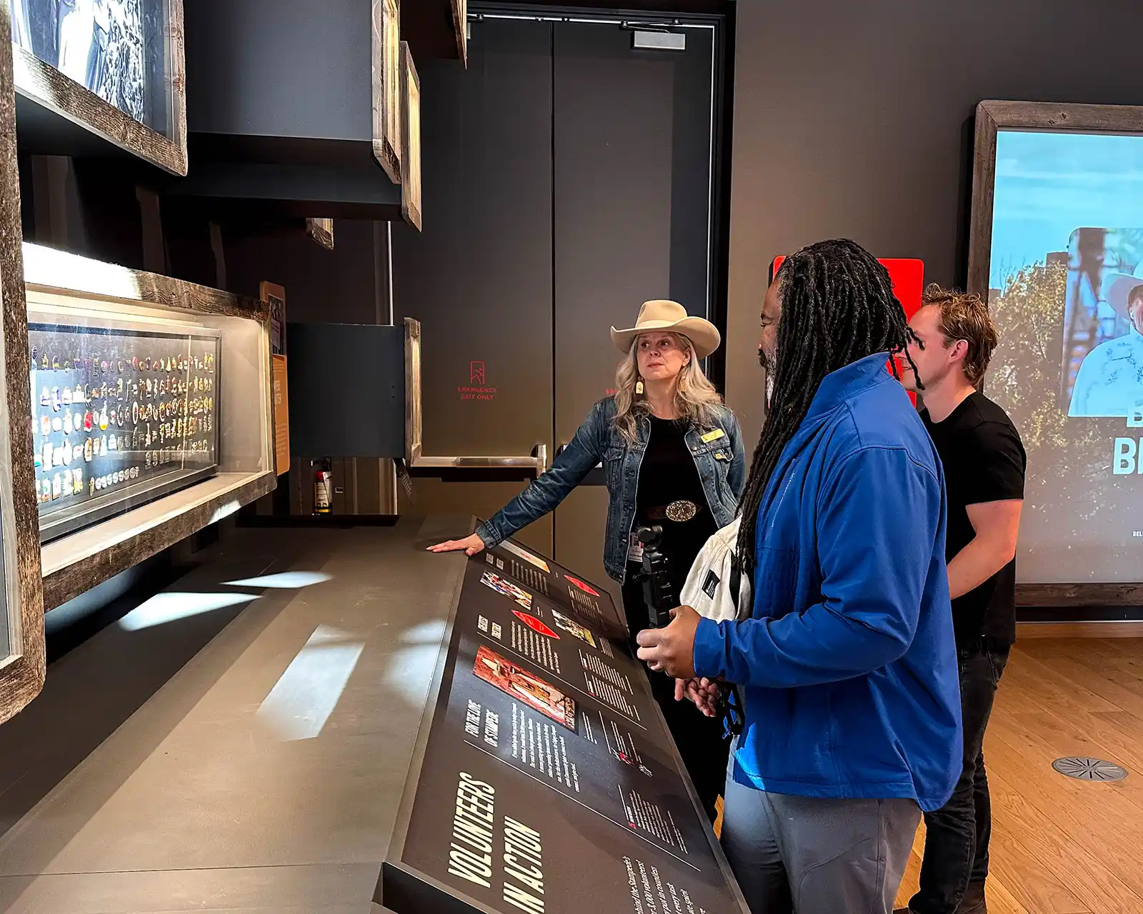 A Sam Centre guide explains exhibits to Christopher Rudder and Tyler MacSemniuk