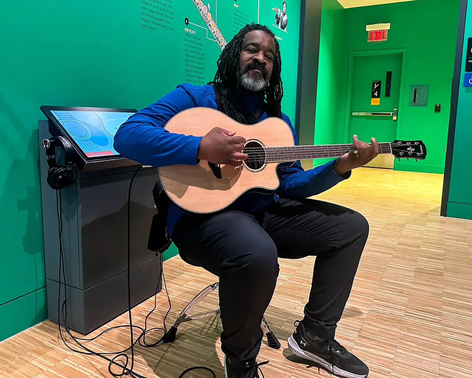 Christopher Rudder strums a guitar at Studio Bell in Calgary