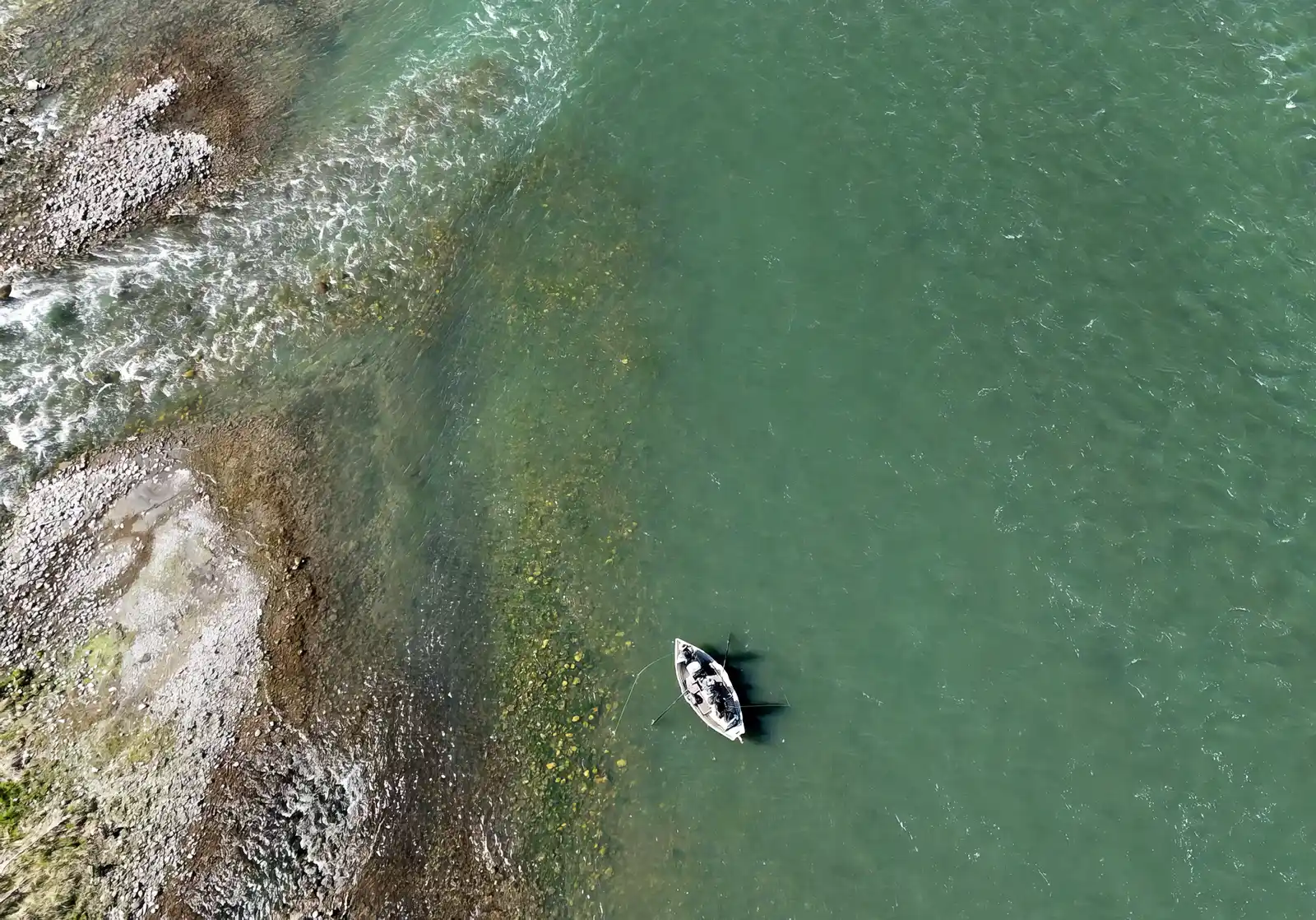 A fly fishing boat floats down the Bow River in Calgary