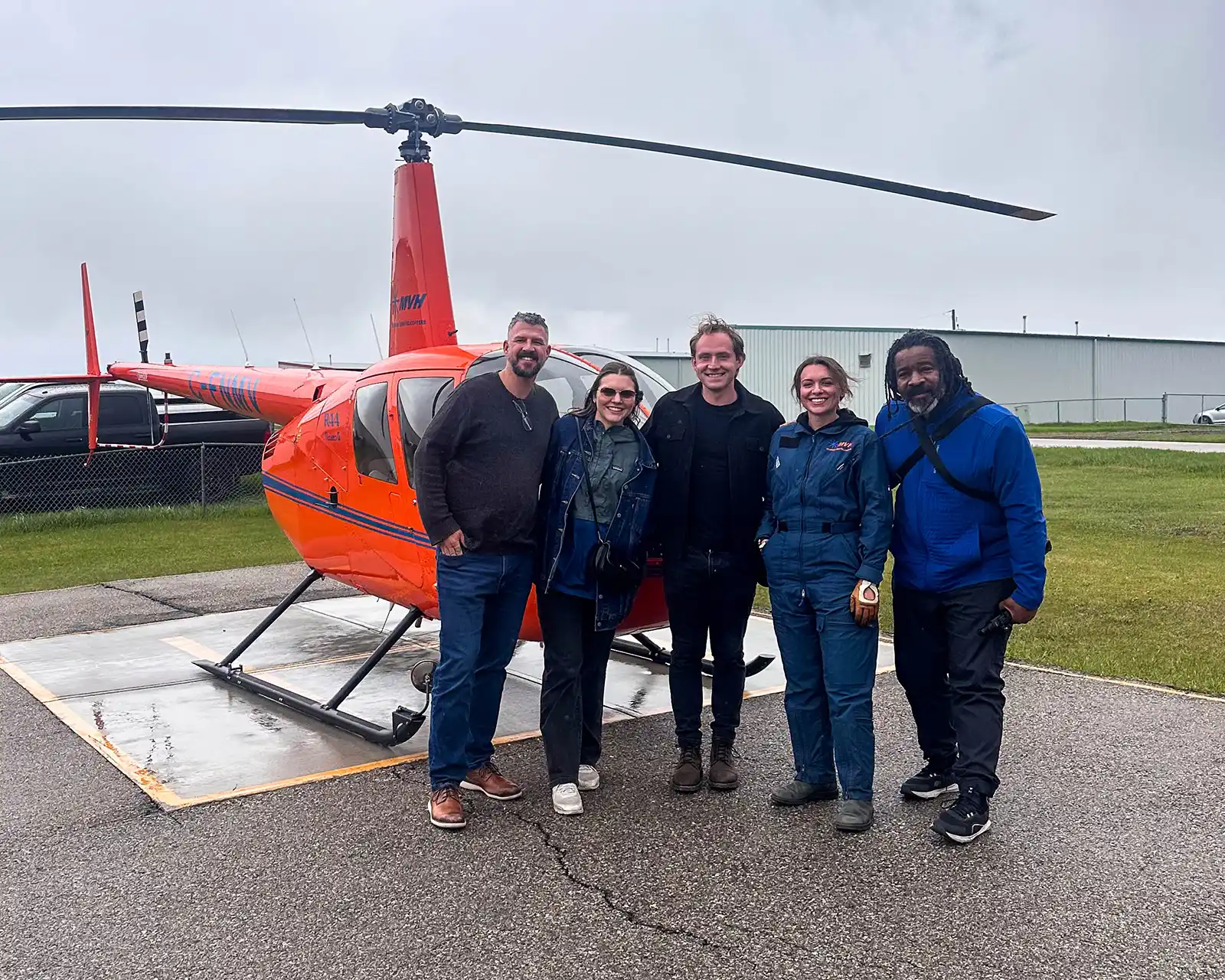 Kevin Wagar, Chris Rudder, Tyler MacSemniuk, and Colleen Chastelet pose with Mountainview Helicopters pilot Briana